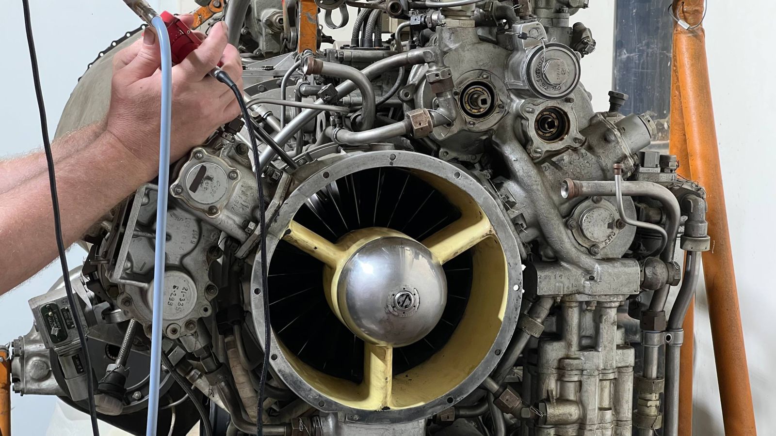 Technician inserting blendoscope probe into turbine engine access port